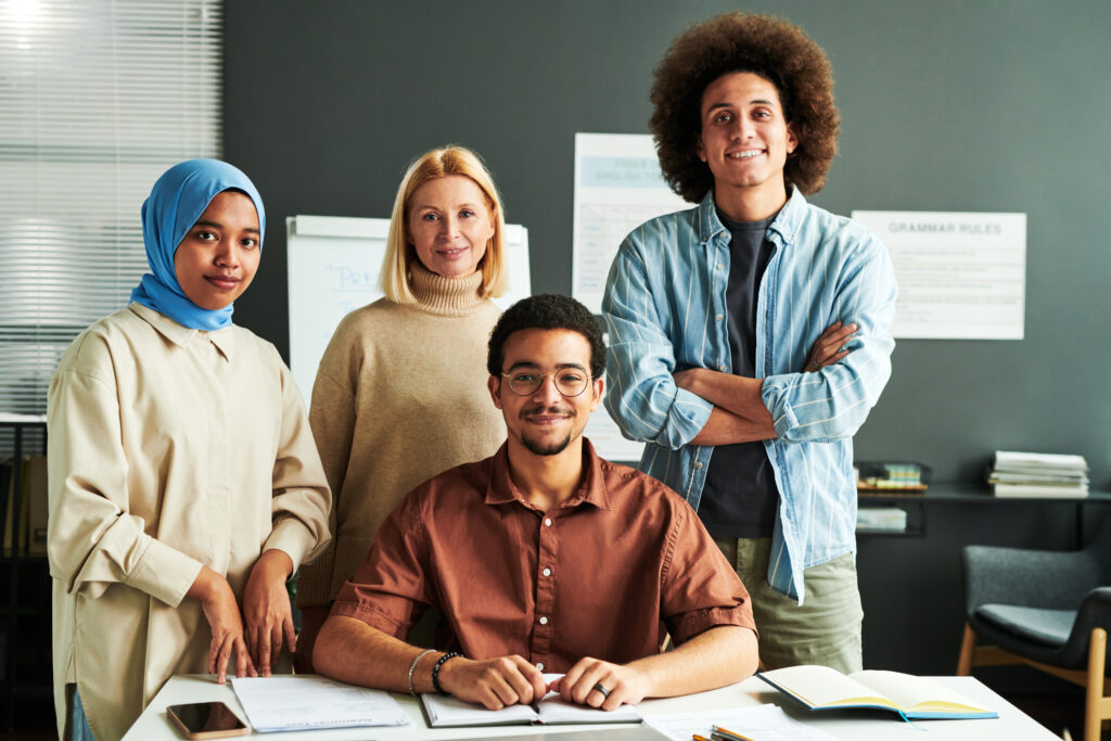 Group of multicultural students and mature blond teacher